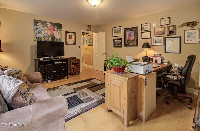 office with light hardwood / wood-style floors