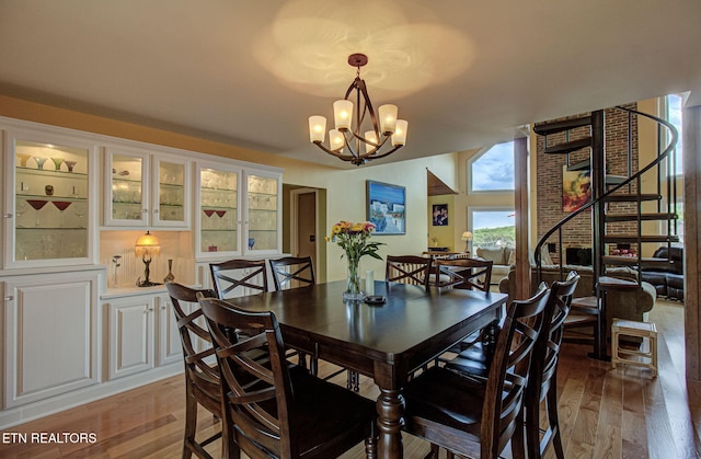 dining area featuring a chandelier and light wood-type flooring