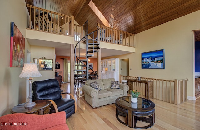 living room featuring light wood-type flooring, wood ceiling, high vaulted ceiling, and a skylight