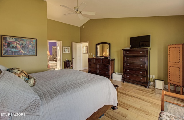 bedroom featuring connected bathroom, ceiling fan, light hardwood / wood-style flooring, and lofted ceiling