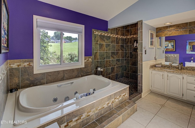 bathroom featuring tile patterned floors, vanity, shower with separate bathtub, and vaulted ceiling