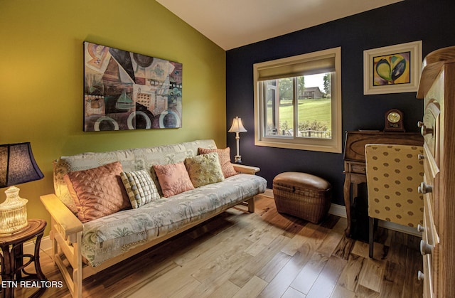 sitting room with vaulted ceiling and light hardwood / wood-style flooring