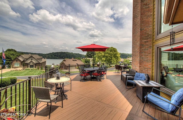 wooden deck featuring a lawn