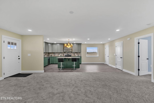 unfurnished living room with carpet flooring and a notable chandelier