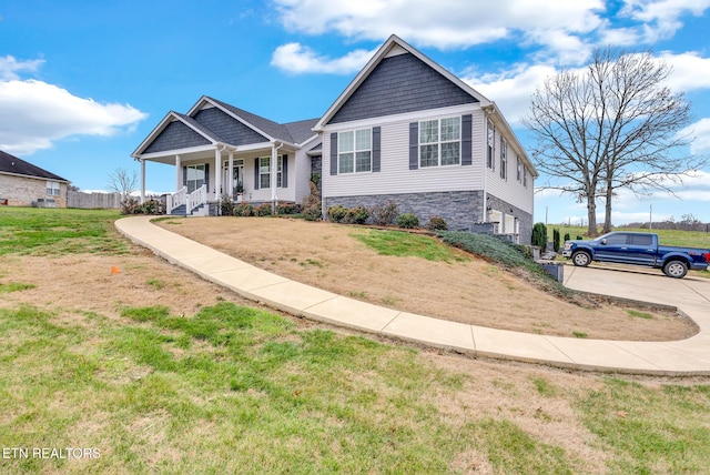 view of front of home with covered porch and a front yard