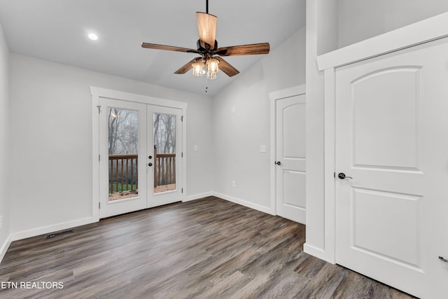 unfurnished room featuring ceiling fan, lofted ceiling, dark wood-type flooring, and french doors