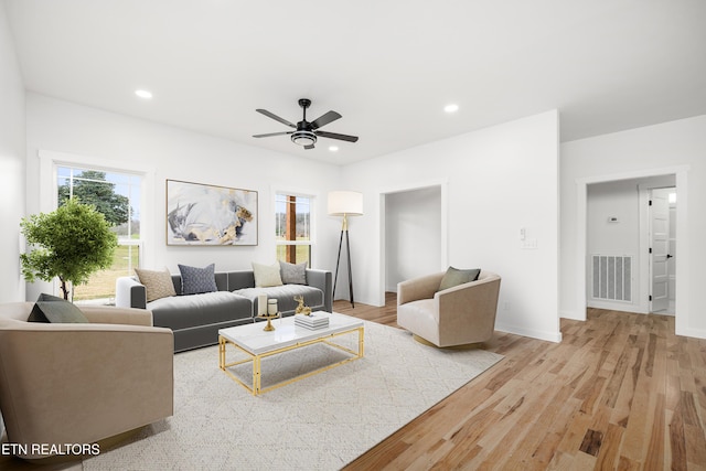 living room with ceiling fan and light hardwood / wood-style floors