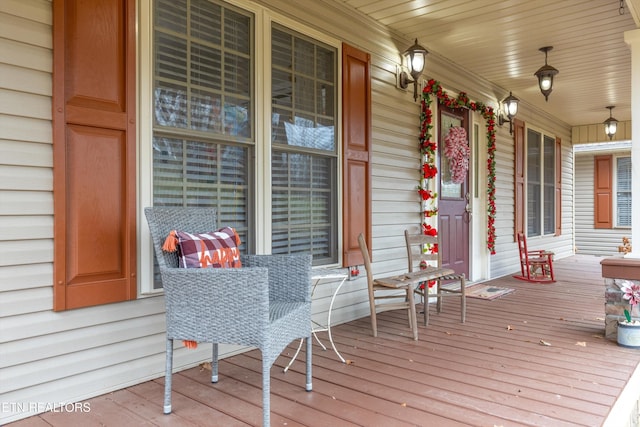 wooden terrace with a porch