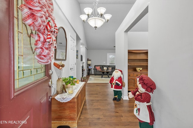 entrance foyer with a chandelier and dark hardwood / wood-style floors