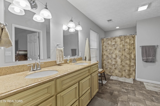 bathroom with vanity, a textured ceiling, and a shower with shower curtain