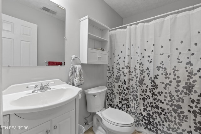 bathroom featuring vanity, a shower with curtain, a textured ceiling, and toilet