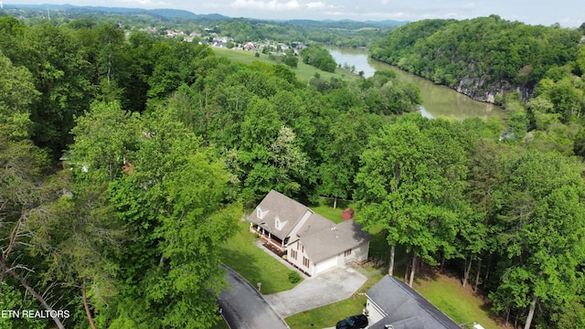 drone / aerial view with a view of trees and a water view