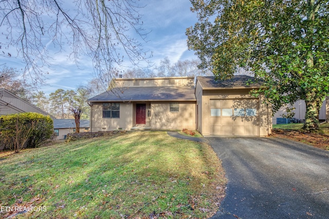 view of front facade with a garage and a front lawn