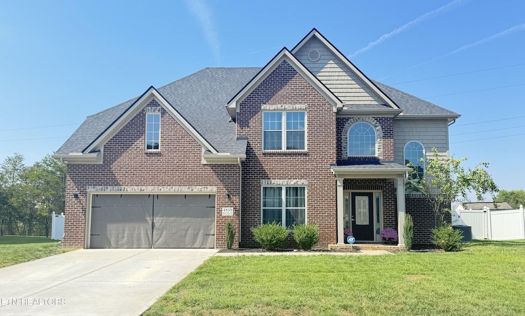 view of front of property with a garage and a front lawn