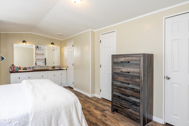 bedroom featuring dark hardwood / wood-style floors, vaulted ceiling, and crown molding