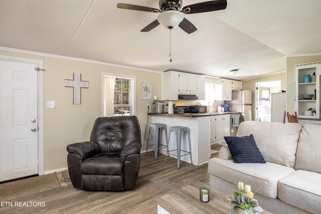 living room featuring ornamental molding, dark hardwood / wood-style floors, ceiling fan, and lofted ceiling