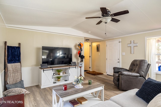 living room featuring ceiling fan, light hardwood / wood-style flooring, crown molding, and lofted ceiling