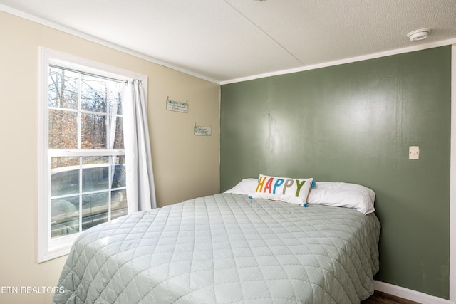 bedroom with crown molding and a textured ceiling