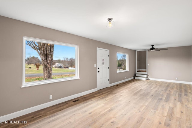 entrance foyer with ceiling fan, light hardwood / wood-style flooring, and a healthy amount of sunlight