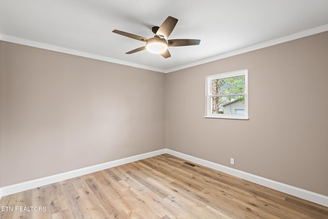 spare room with crown molding, ceiling fan, and light wood-type flooring