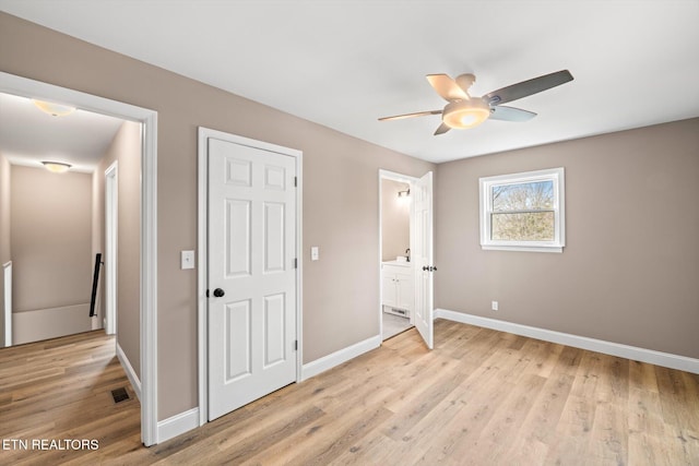 unfurnished bedroom with ceiling fan and light wood-type flooring