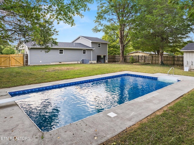 view of swimming pool with a lawn and cooling unit