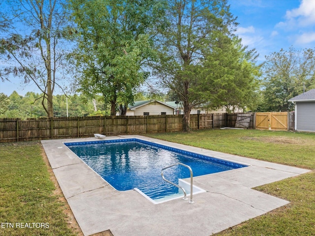 view of pool with a lawn and a patio area