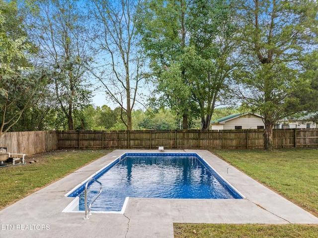 view of pool with a lawn