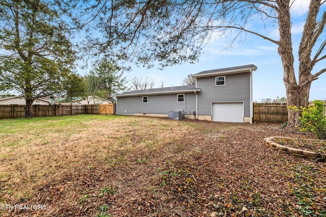 back of property with a yard and a garage