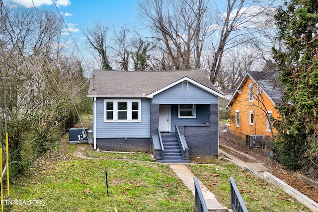 bungalow-style home with a front yard