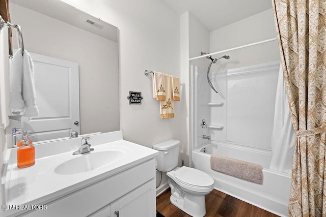 full bathroom with shower / bath combination with curtain, toilet, wood-type flooring, and vanity