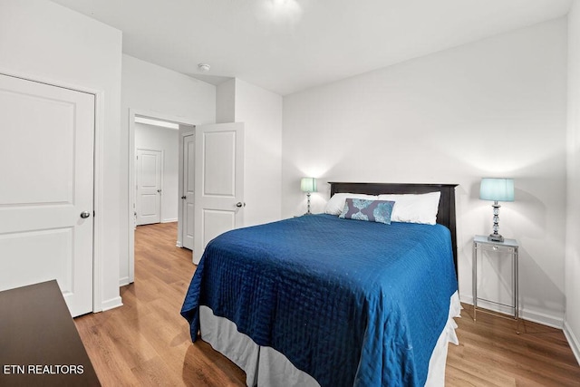 bedroom with wood-type flooring