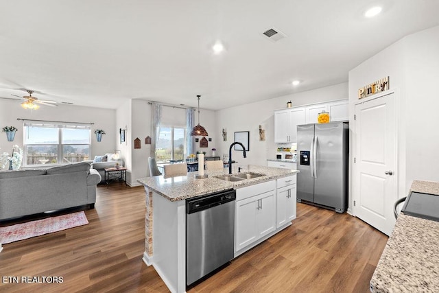 kitchen with white cabinets, sink, hardwood / wood-style flooring, ceiling fan, and appliances with stainless steel finishes