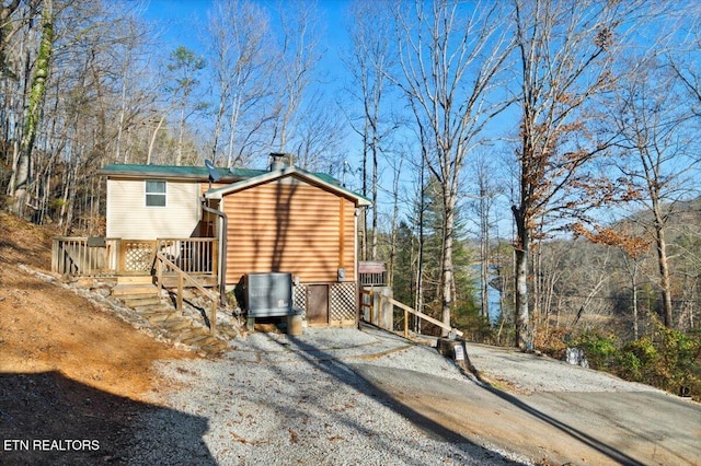 back of house with central AC unit