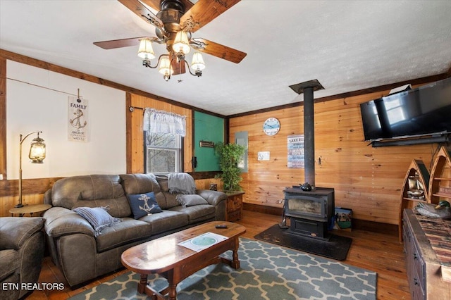 291 Marina Ln, Lafollette, TN 37766 - living room with a wood stove, wooden walls, hardwood / wood-style floors, and ceiling fan
