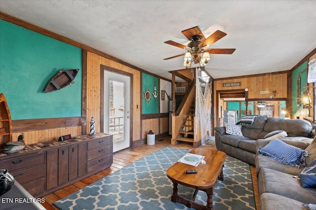 291 Marina Ln, Lafollette, TN 37766 - living room featuring crown molding, wooden walls, light hardwood / wood-style floors, and a textured ceiling