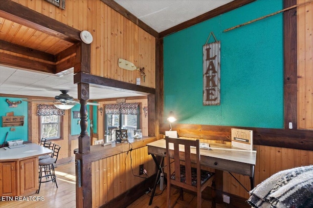 291 Marina Ln, Lafollette, TN 37766 - dining room featuring wood walls, ceiling fan, light hardwood / wood-style floors, and ornamental molding