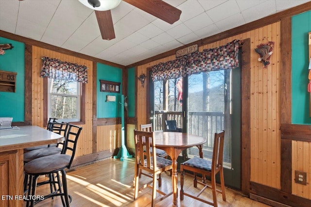 291 Marina Ln, Lafollette, TN 37766 - dining room with wood-type flooring, ceiling fan, ornamental molding, and wood walls
