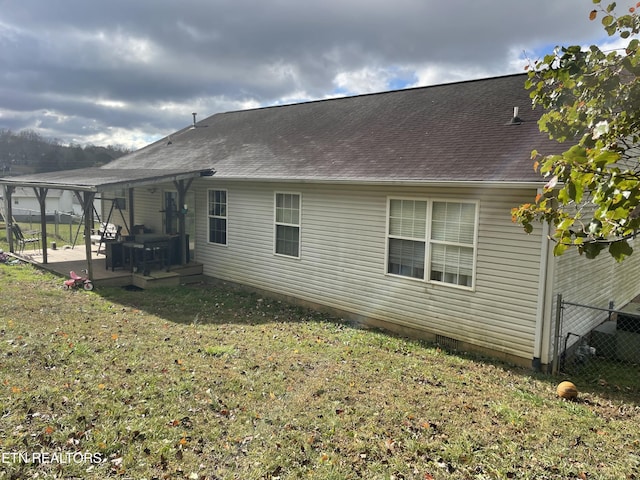 view of side of home with a lawn and a patio