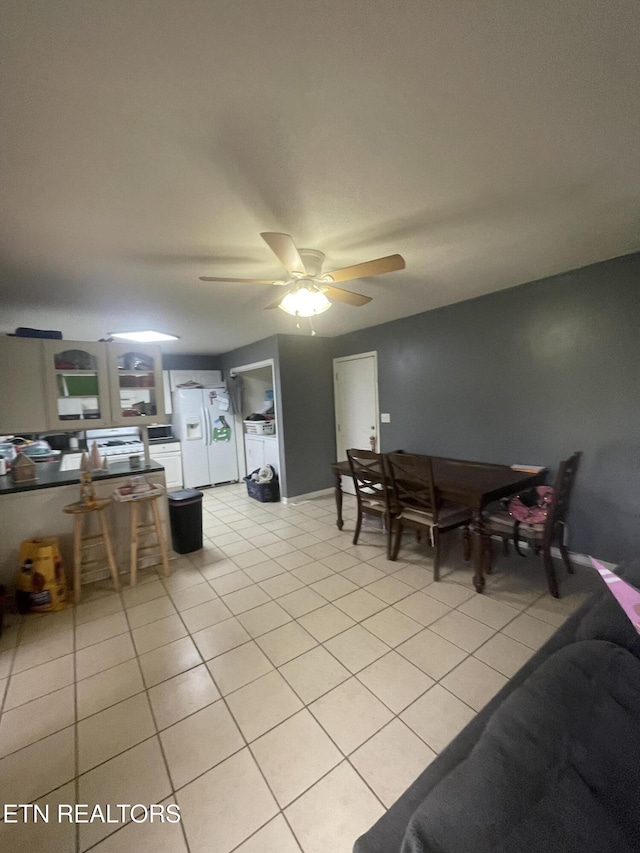 dining space featuring ceiling fan and light tile patterned flooring