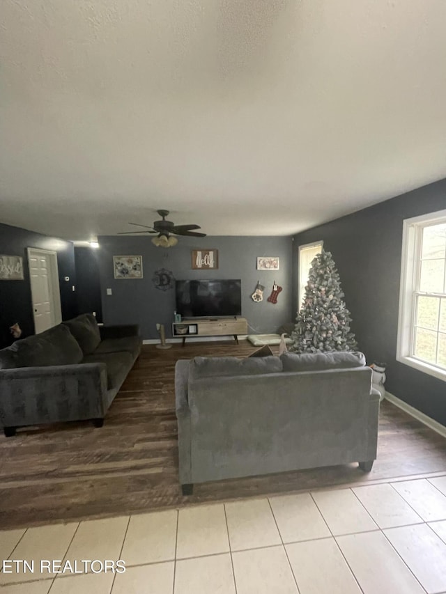 living room featuring ceiling fan and light tile patterned flooring