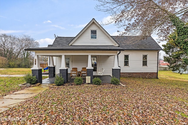 view of front of property with covered porch and a front yard