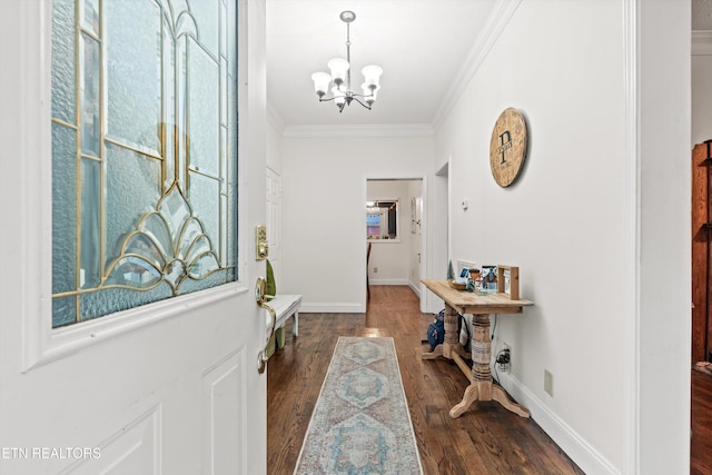 entrance foyer with dark hardwood / wood-style flooring, crown molding, and a chandelier