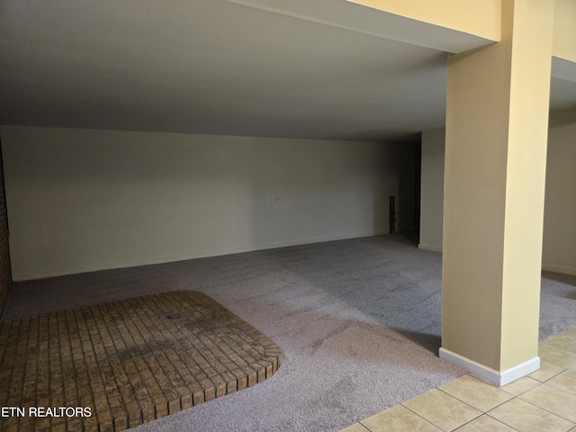 interior space featuring baseboards, tile patterned flooring, and carpet floors