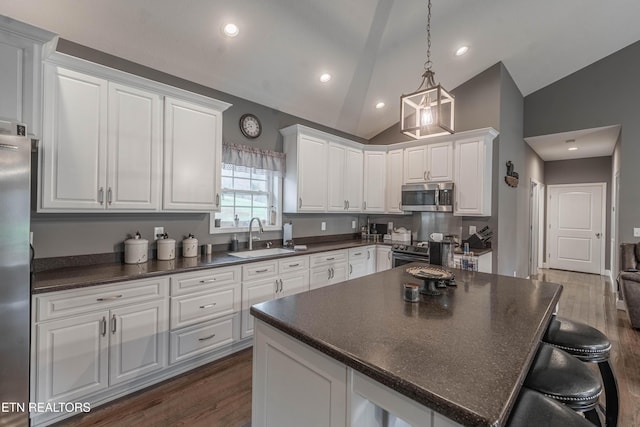 kitchen featuring sink, white cabinets, dark hardwood / wood-style floors, and appliances with stainless steel finishes