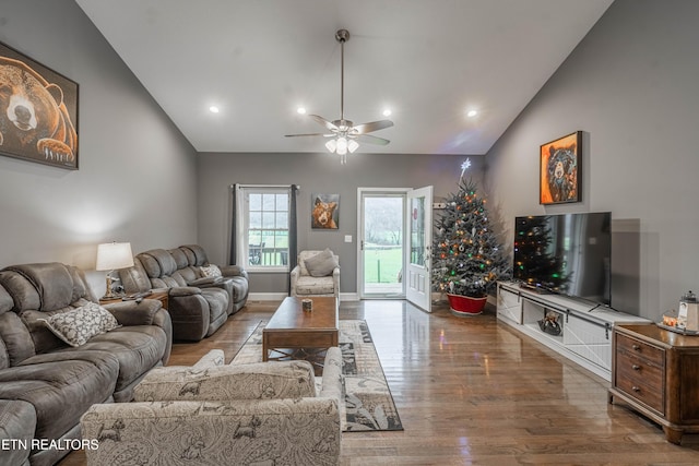 living room featuring ceiling fan, lofted ceiling, and hardwood / wood-style flooring