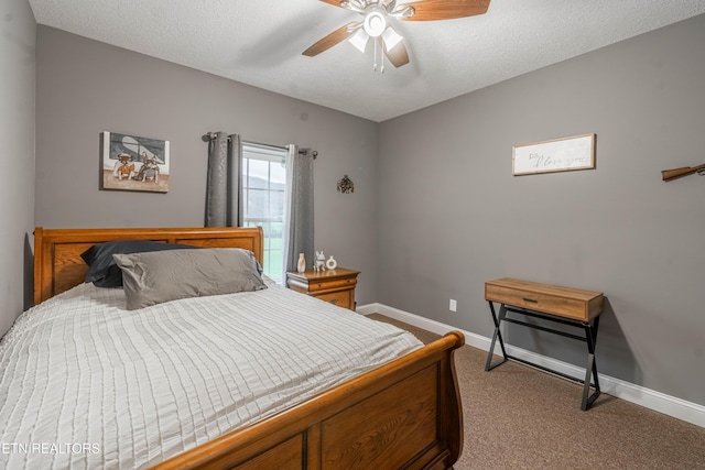 carpeted bedroom with ceiling fan and a textured ceiling