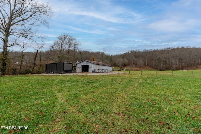 view of yard featuring a rural view and an outdoor structure