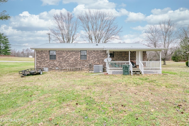 back of house featuring a lawn, central AC unit, and a porch