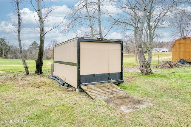 view of outbuilding with a lawn